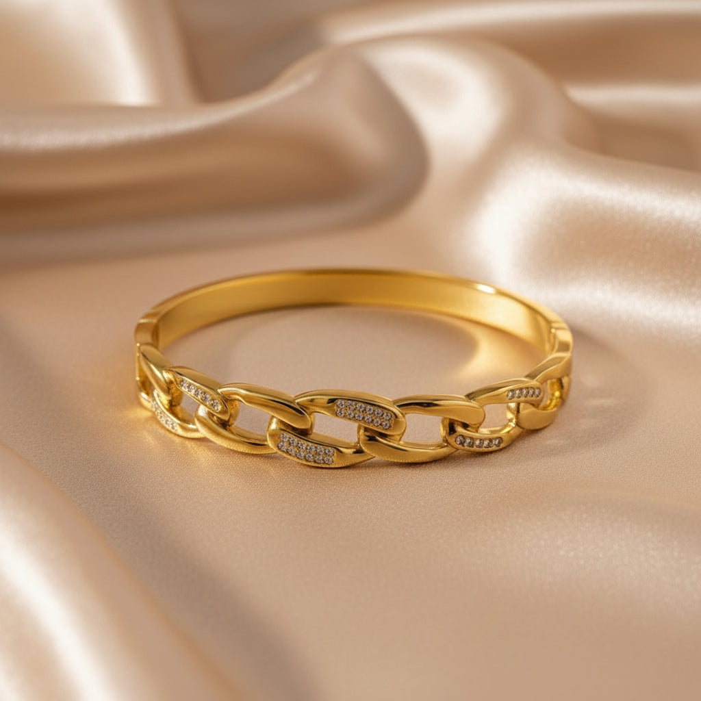 Altin Noor gold-tone chain link bangle bracelet featuring polished metal and delicate pavé-set crystal accents.