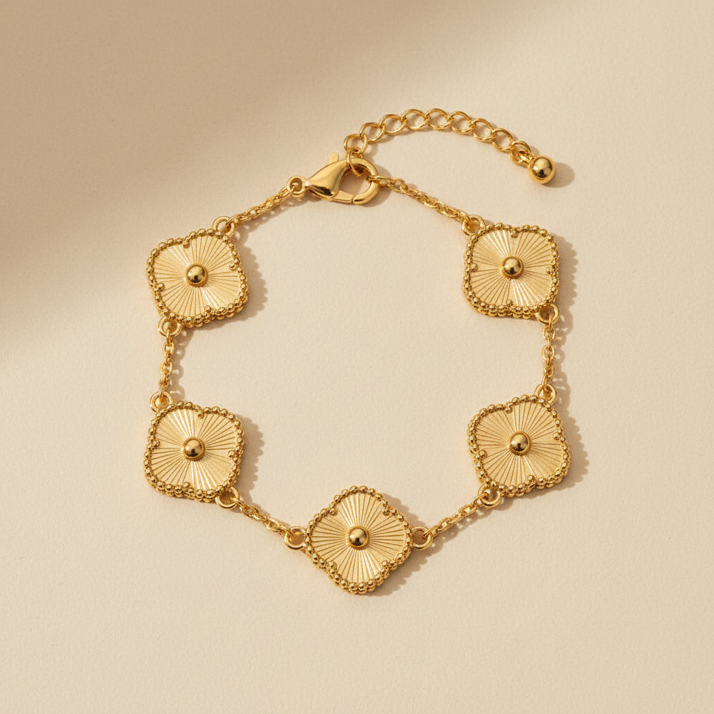 Altin Noor gold-tone link chain bracelet featuring five textured clover charms with central beads and lobster clasp.