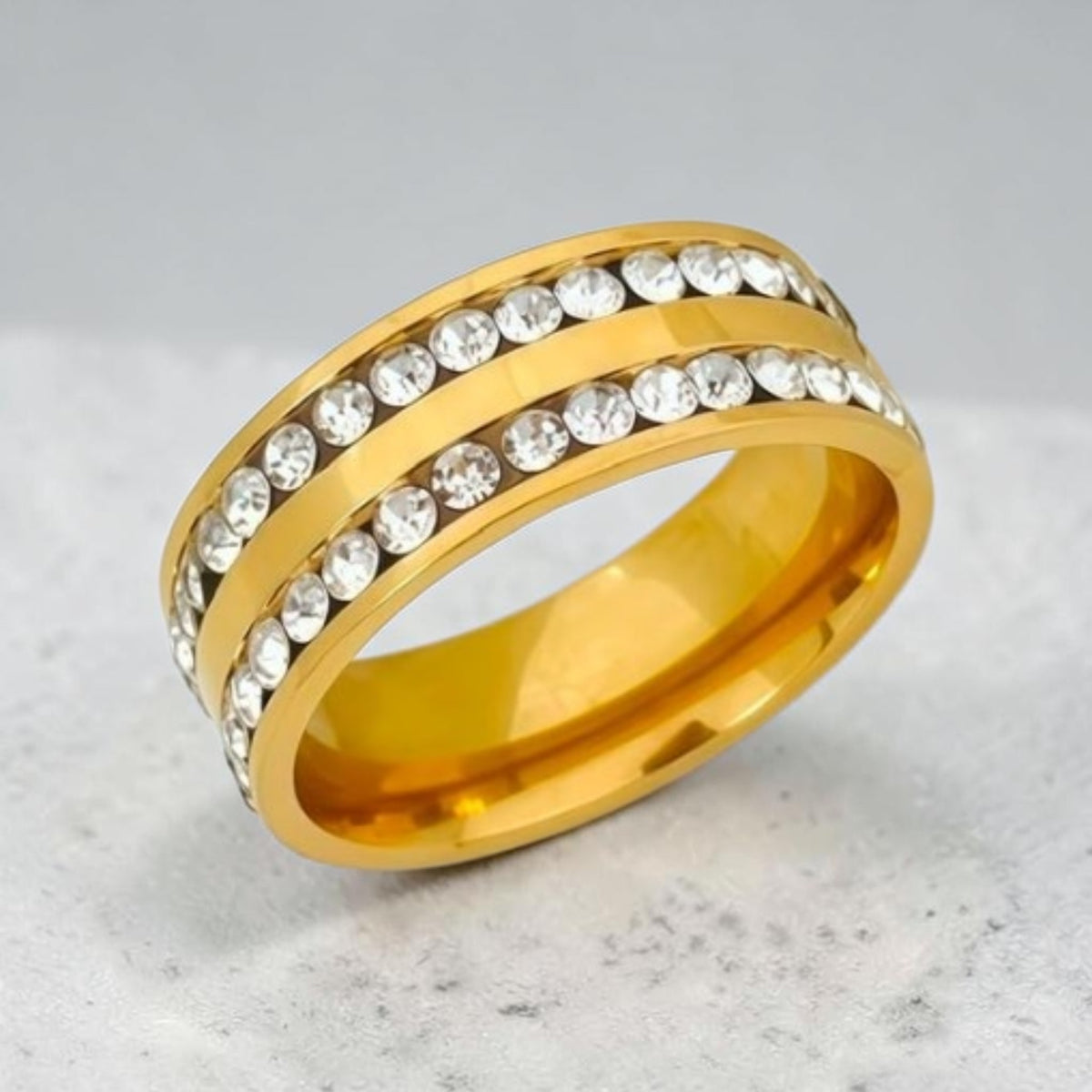 Altin Noor gold-tone stainless steel band ring featuring two rows of sparkling clear cubic zirconia crystals.