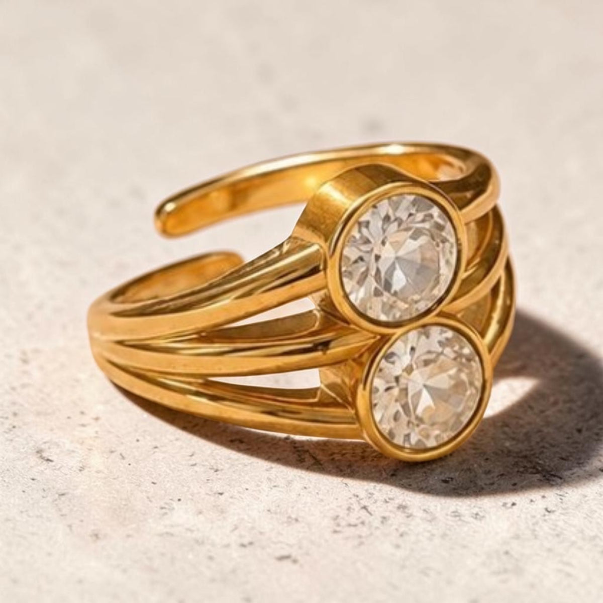 Altin Noor gold-tone statement ring with a multi-band open design and two brilliant round-cut clear crystals.