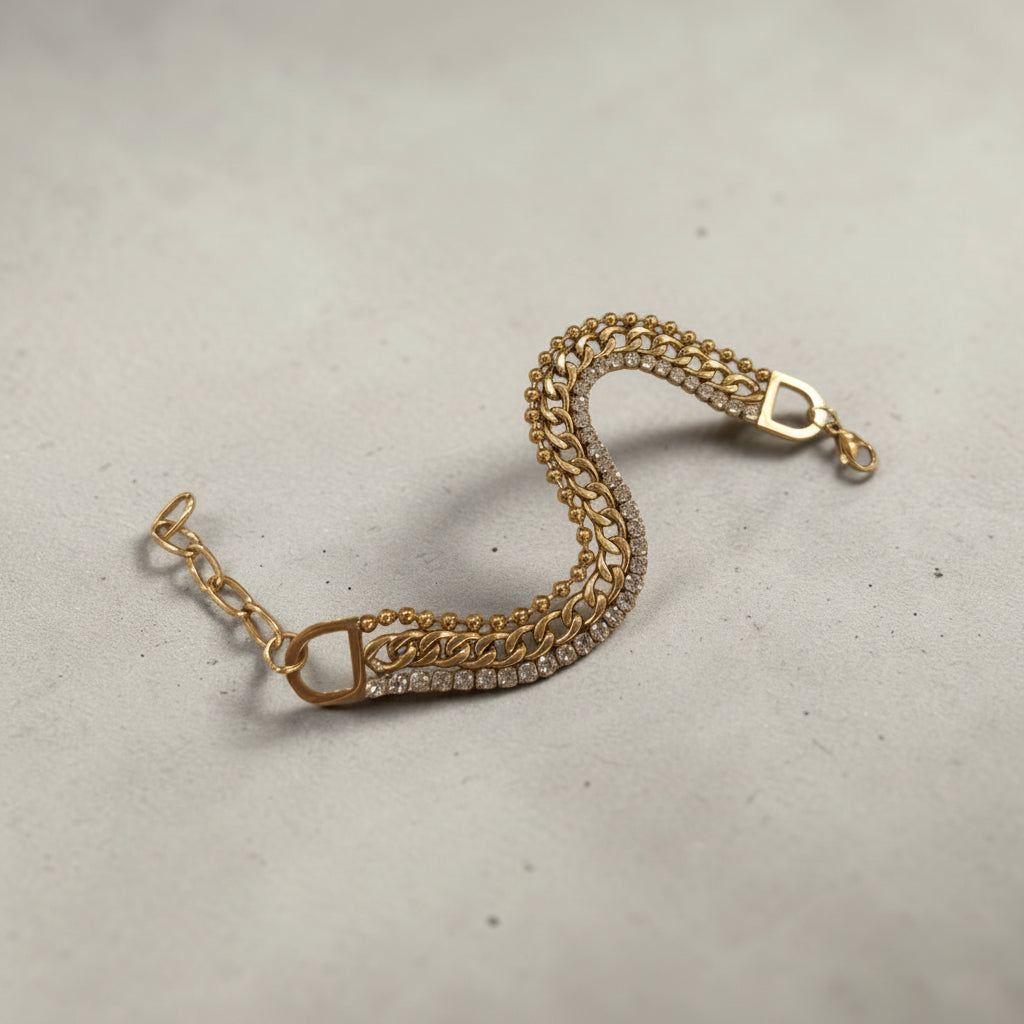 Altin Noor gold-tone multi-layered chain bracelet featuring beaded and curb chains with clear crystal accents.