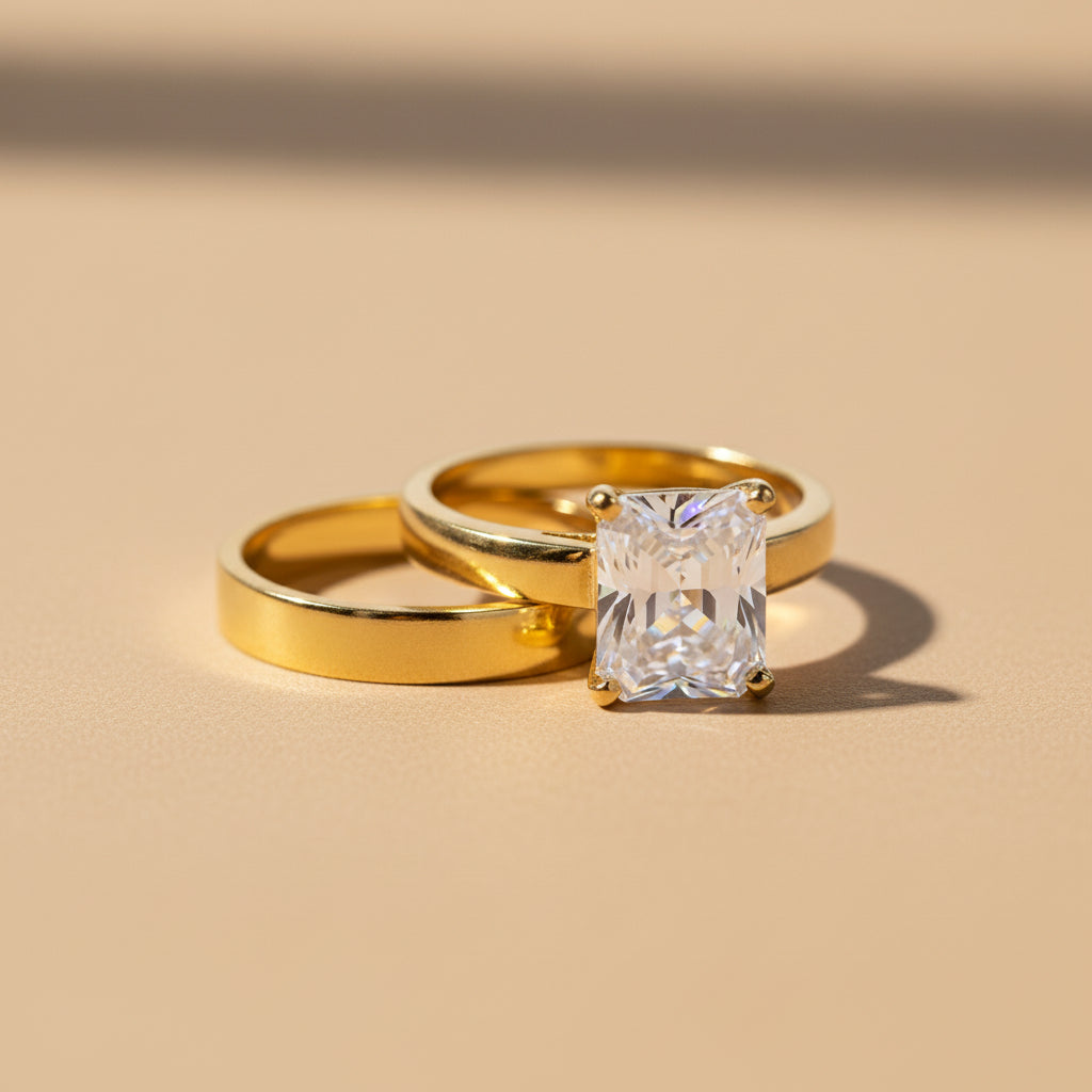 Altin Noor gold-tone engagement ring set featuring a brilliant rectangular-cut clear stone on a polished band